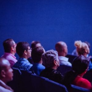 people sitting in audience for conference presentation