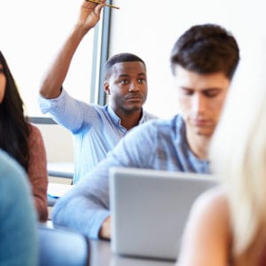 young african american man raising hand in class